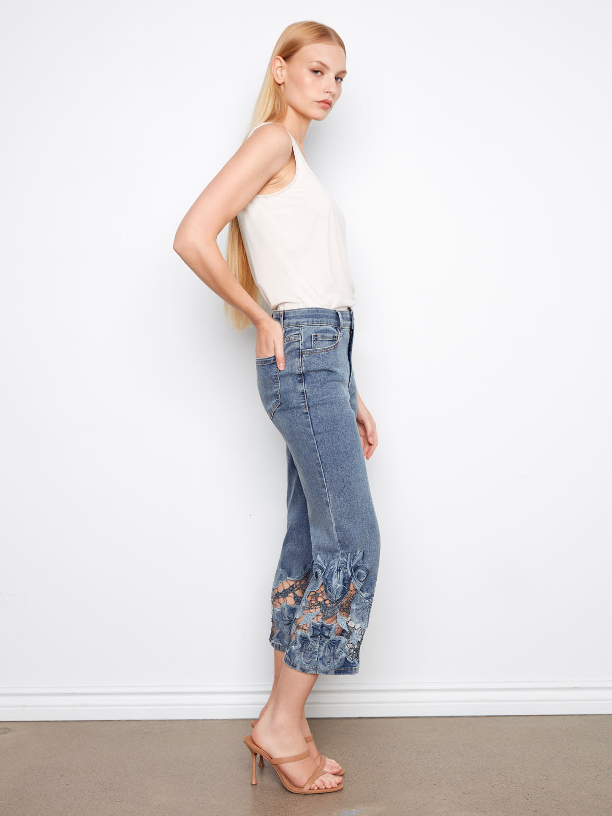 Side view of Charlie B Open Lace 25” Wide Denim Capris featuring denim with lace detailing at hem by Charlie B
