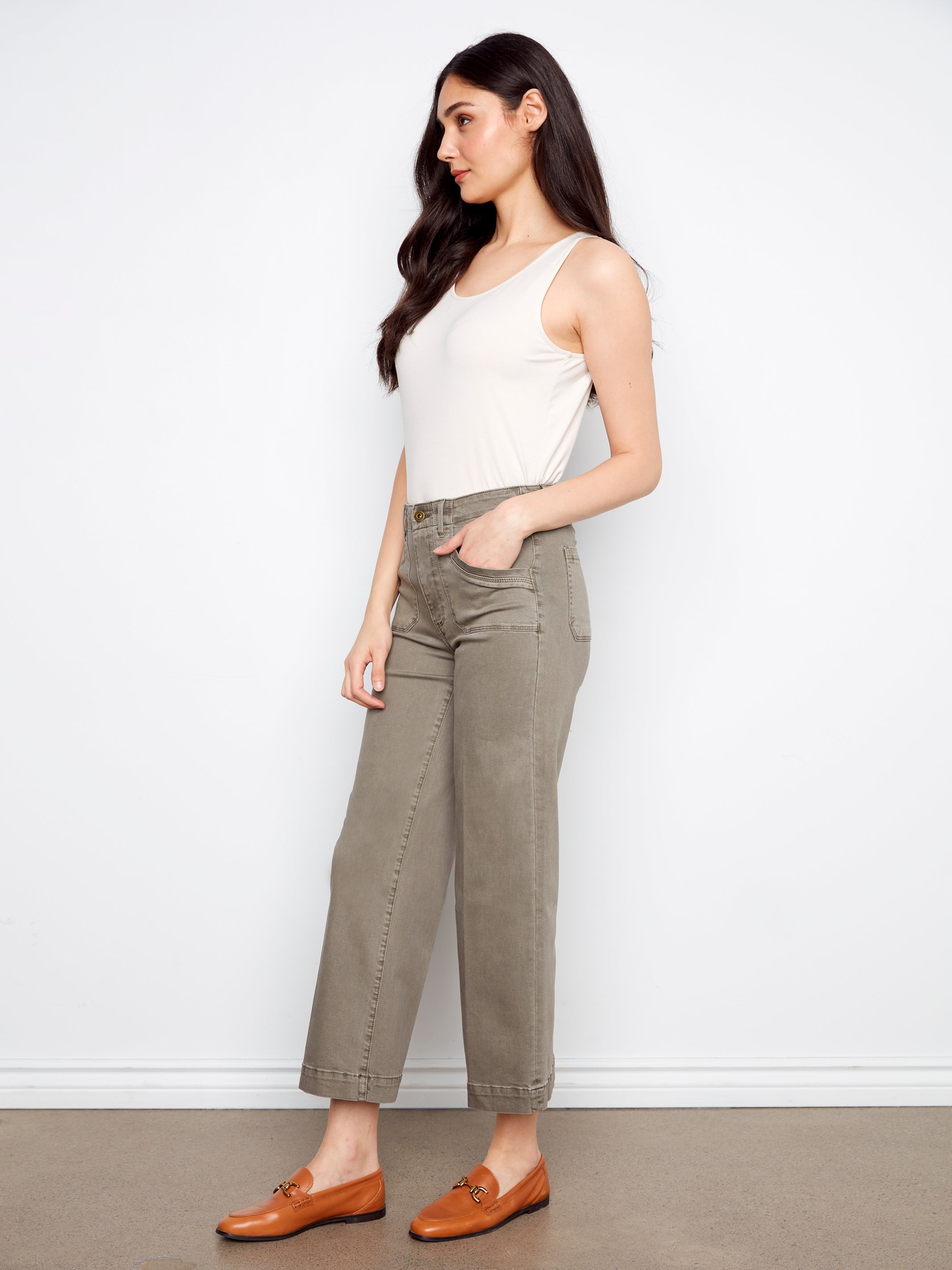 Model in Charlie B Lola Double Pocket 27” Twill Wide Pants in sage by Charlie B with white tank top and brown loafers
