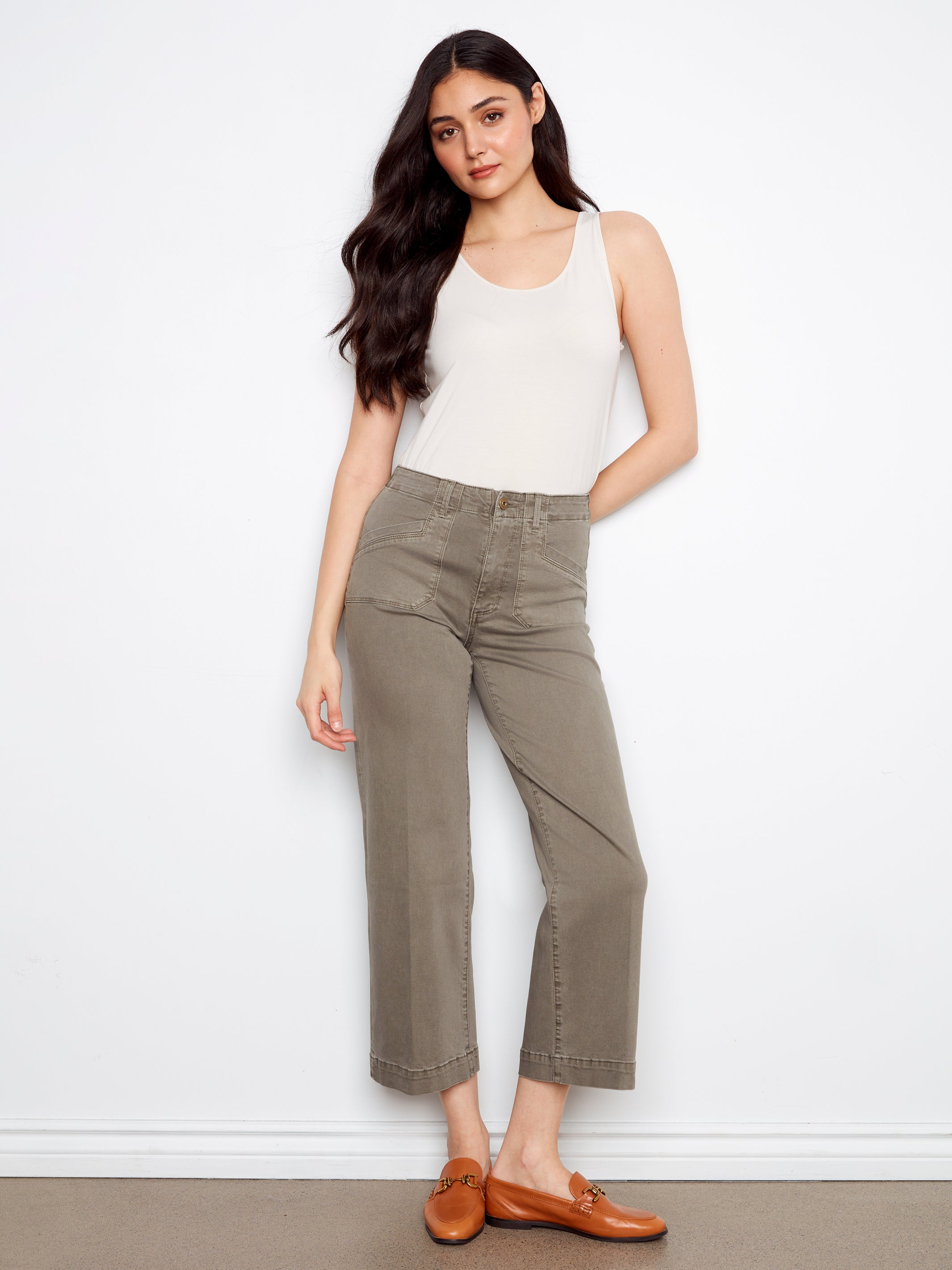 Model wearing Charlie B Lola Double Pocket 27” Twill Wide Pants in sage by Charlie B with white sleeveless top and brown loafers