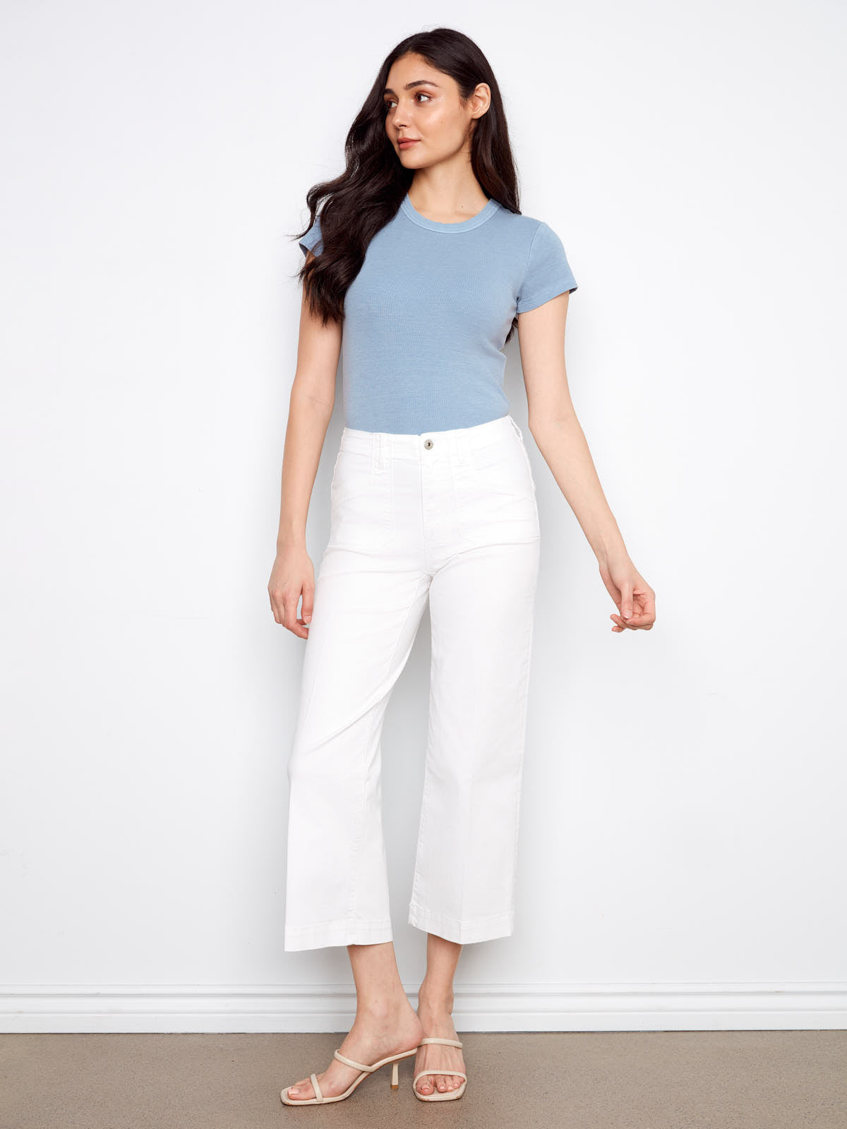Charlie B Lola Double Pocket 27” Twill Wide Pants in white styled with a blue short-sleeve top and beige heels.