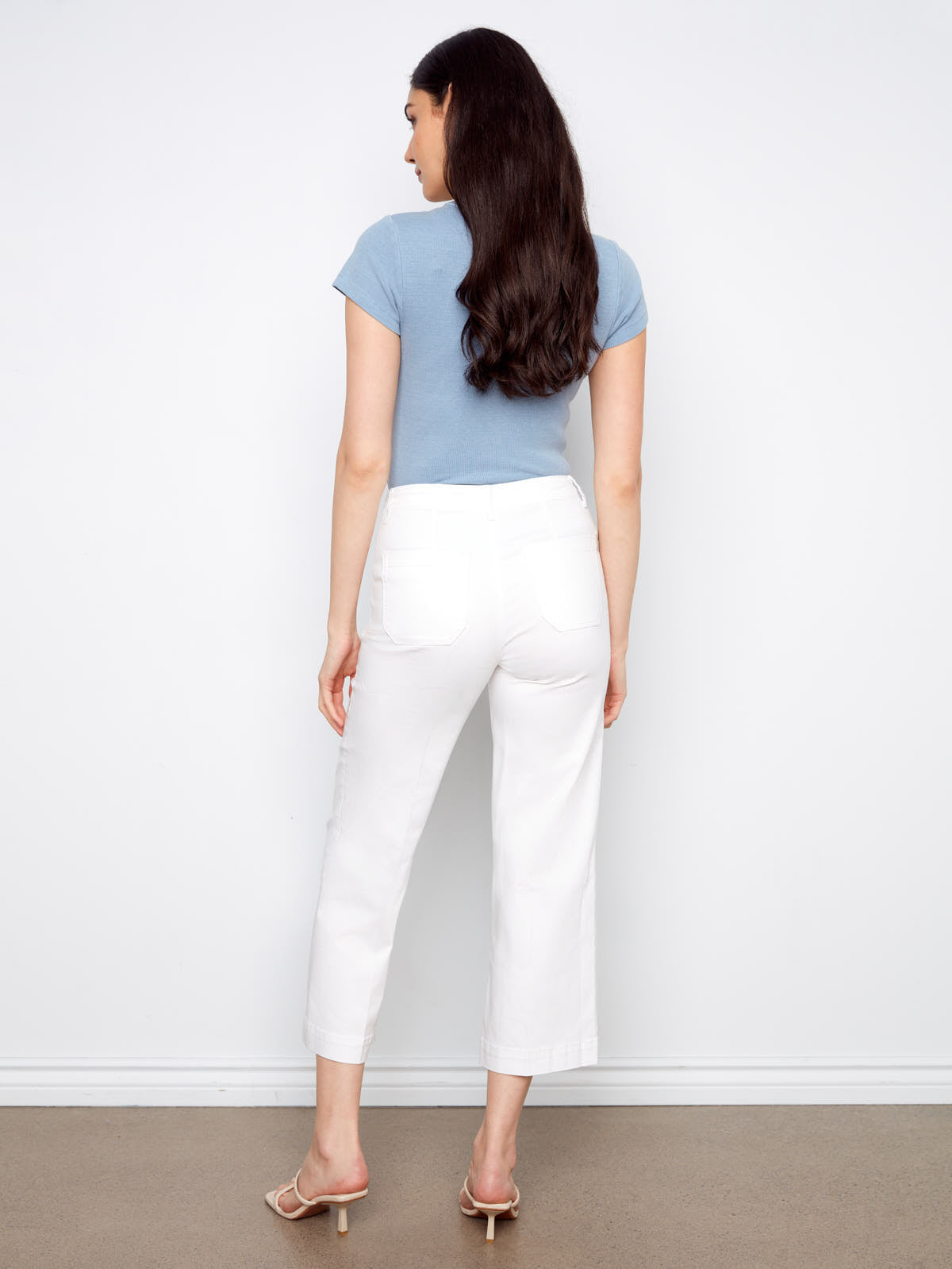 Model from behind wearing Charlie B Lola Double Pocket 27” Twill Wide Pants in white by Charlie B with light blue top