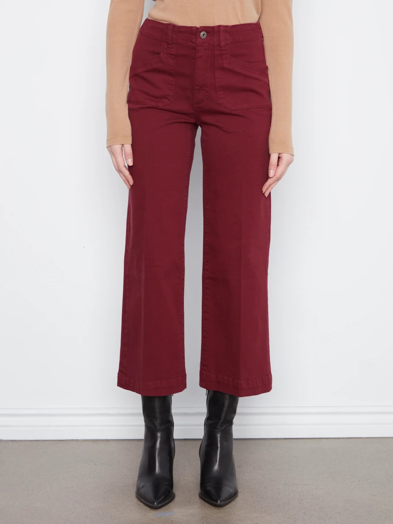 Charlie B Lola Double Pocket 27" Wide Leg Color Twill Pants in dark red styled with black boots and beige top.