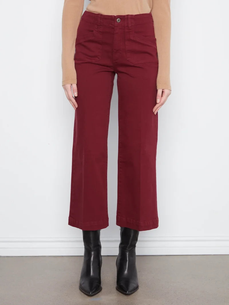 Front view of burgundy wide-leg pants with a tan long-sleeve top and black ankle boots