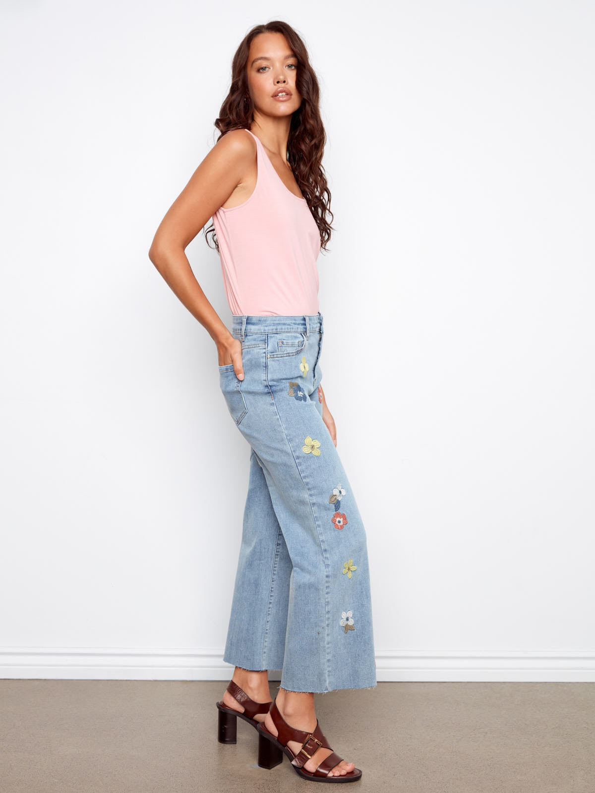 Light blue Charlie B Embroidered Flower 27” Wide Denim Jeans with colorful floral embroidery and wide leg fit by Charlie B.