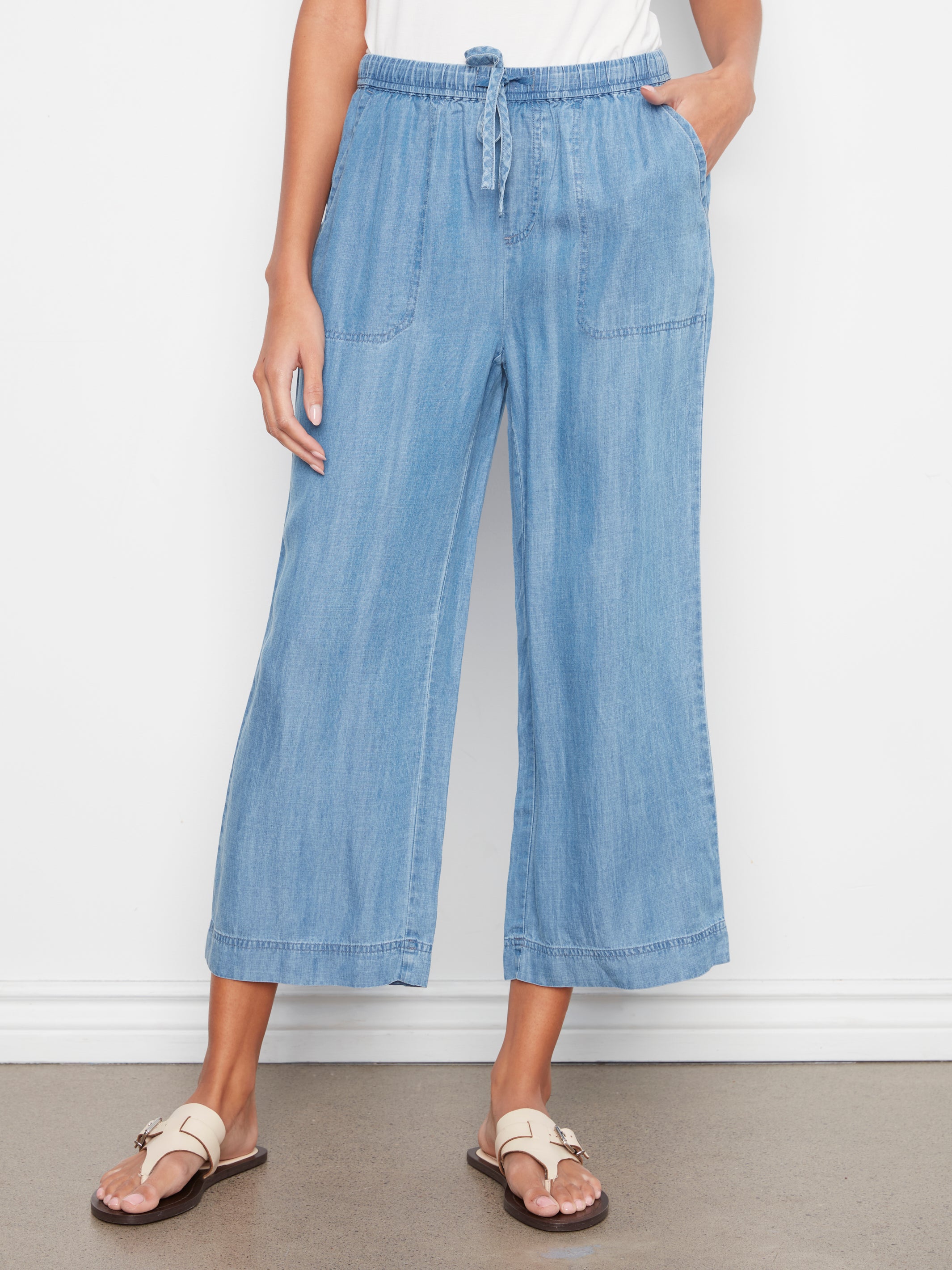 Charlie B Travel 4 Tencel Cropped Pant in light blue denim-style fabric with drawstring waist and front pockets by Charlie B.