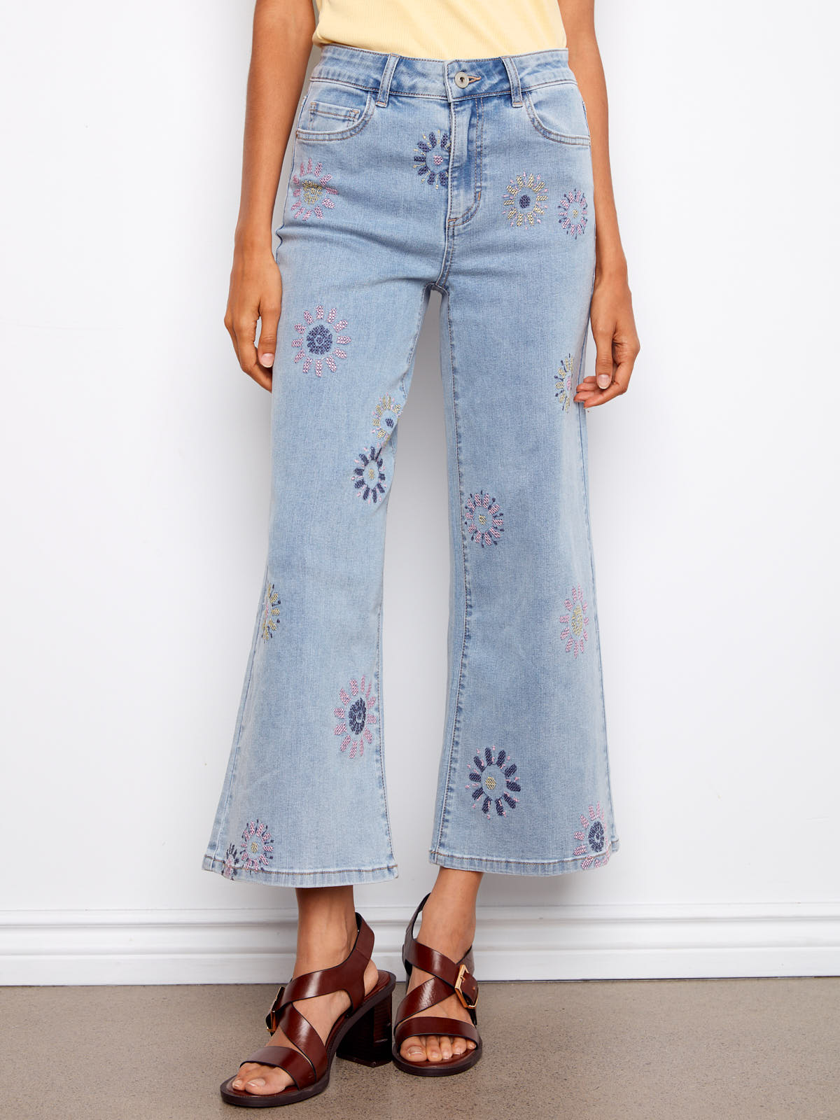 Light wash denim Charlie B Daisy Beads Embroidered Denim Jeans with floral embroidery and flared legs by Charlie B.