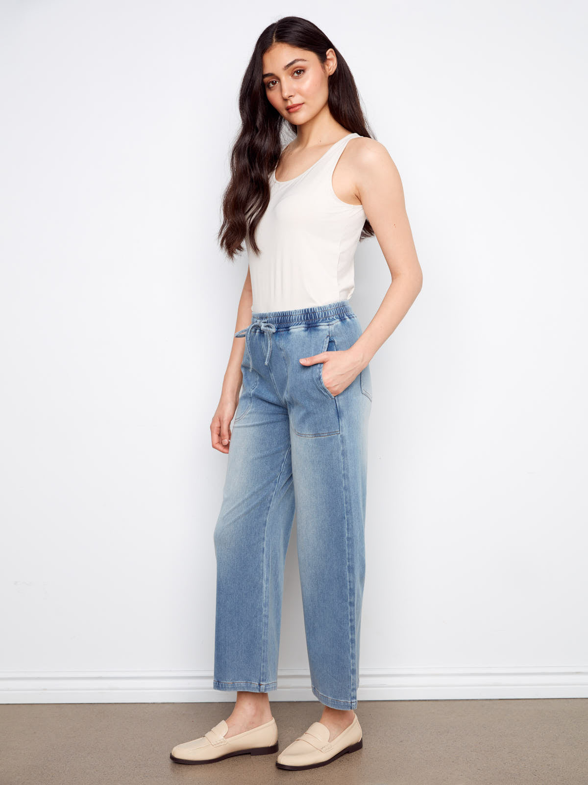 Light blue denim Charlie B Nautical Tie Waist Denim Pant styled with a white tank top and cream loafers