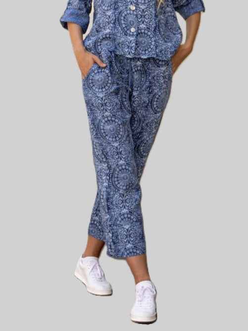 Cherishh Cool Guy Linen Tie Waist Relaxed Pants in blue patterned fabric paired with casual white shoes.