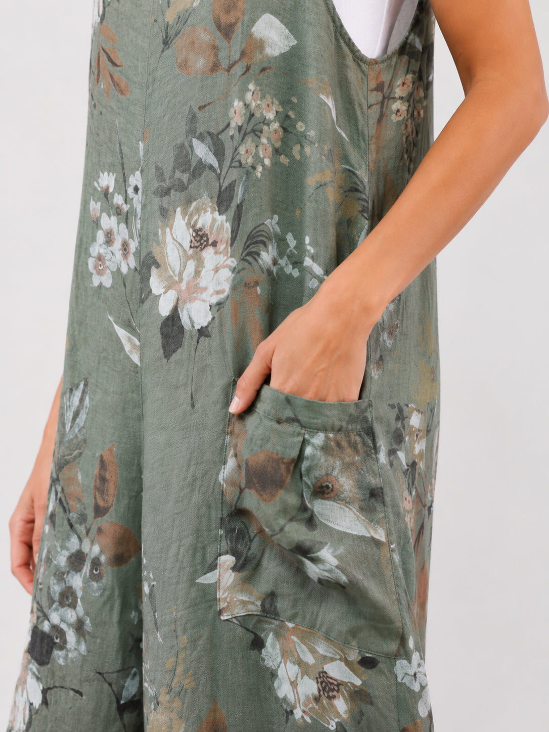 Green floral dress with large side pocket and visible white underlayer on arm area