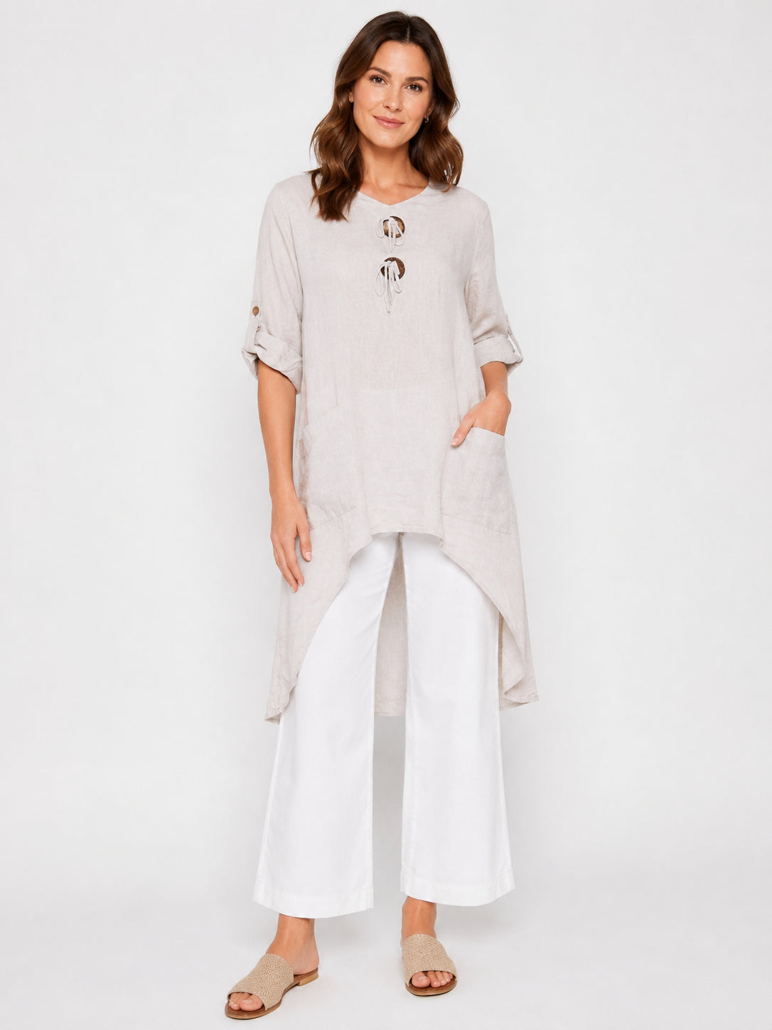 Uneven Hem Double Button Linen 3/4 Sleeve Tunic by Cherishh in beige worn with white wide-leg pants and sandals.