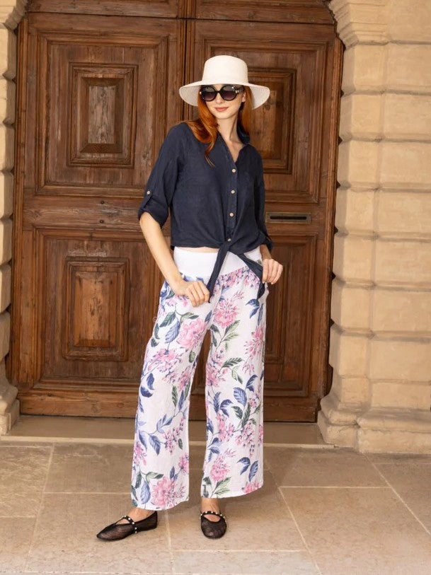 Button Front Linen Tie Front Top in navy by Cherishh styled with sunglasses and white hat outdoors.