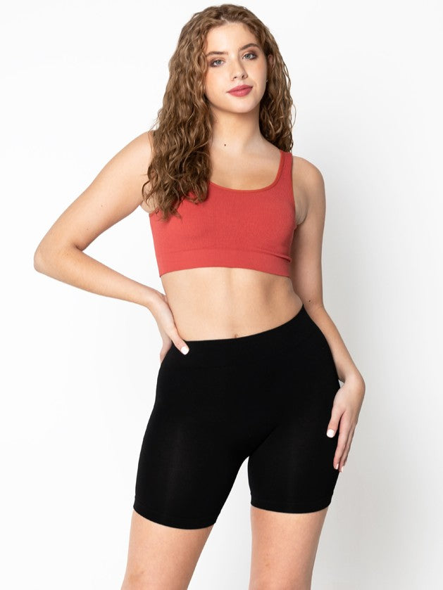Black Bamboo Biker Shorts by Coast To Coast Trading styled with a rust crop top on a white background.