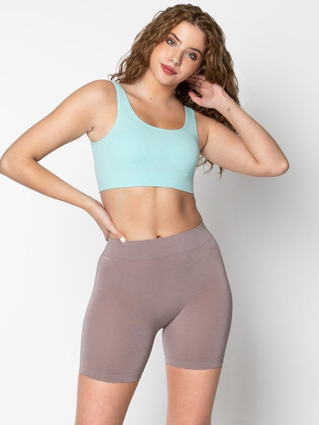 Taupe Bamboo Biker Shorts by Coast To Coast Trading modeled with a light blue crop top against a white background