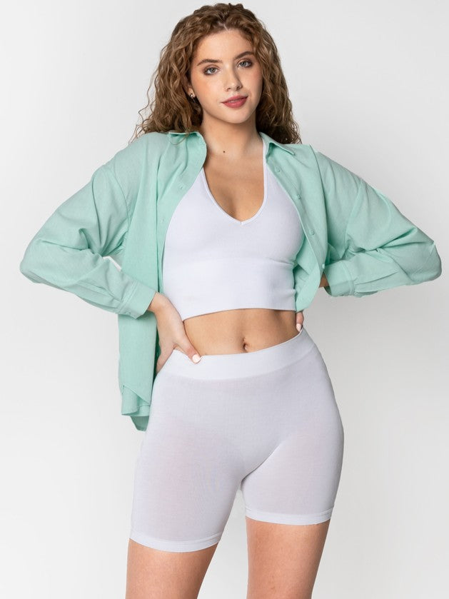White Bamboo Biker Shorts by Coast To Coast Trading styled with a white crop top and mint green open shirt