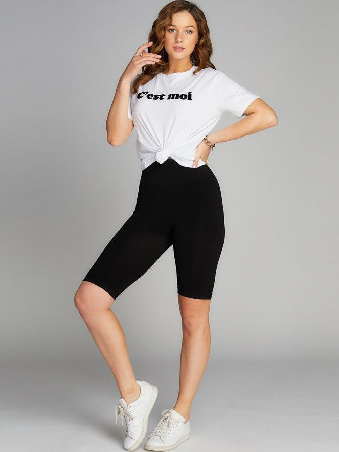 Black High Waist Bamboo Biker Shorts by Coast To Coast Trading styled with a white knotted graphic tee and white sneakers