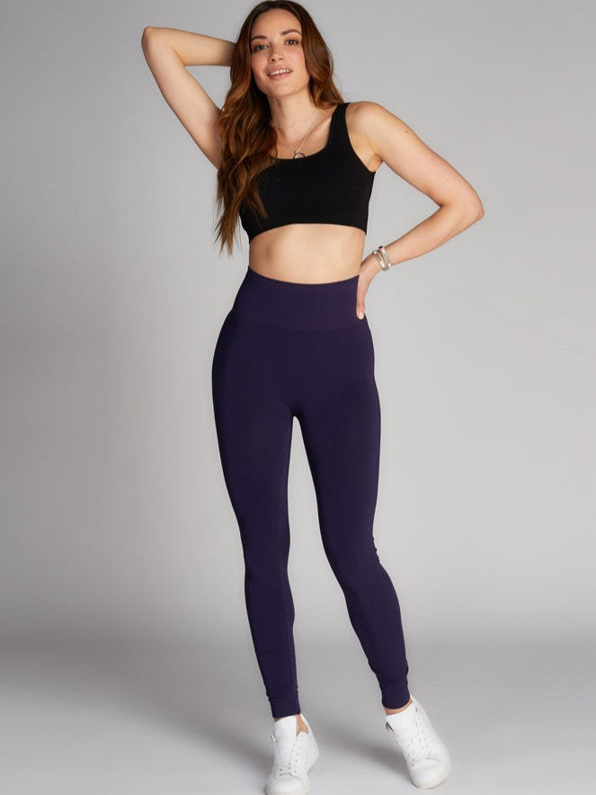 Navy Full Length High Waist Bamboo Leggings by Coast To Coast Trading modeled with black crop top and white sneakers.