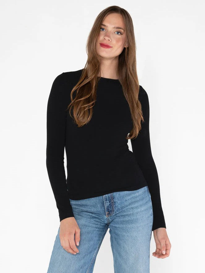 Black Bamboo Long Sleeve Crew Neck Top by Coast To Coast Trading paired with light blue denim jeans against white background