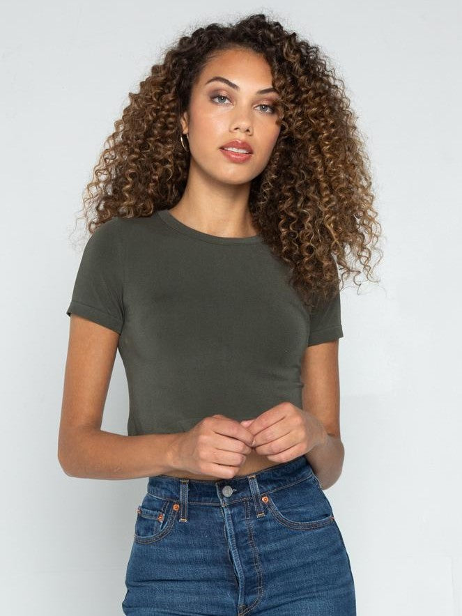 Olive green Bamboo Short Sleeve Crop Top from Coast To Coast Trading paired with blue denim jeans.