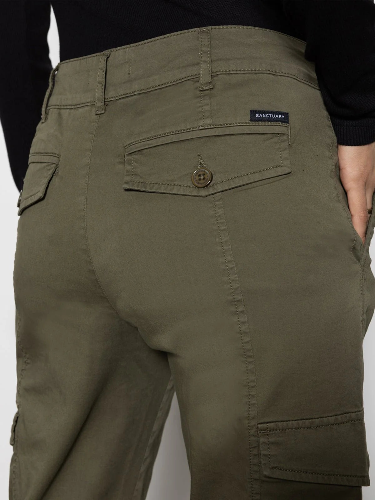 Olive green pants with buttoned back pockets and a black label on the right pocket, paired with a black top.