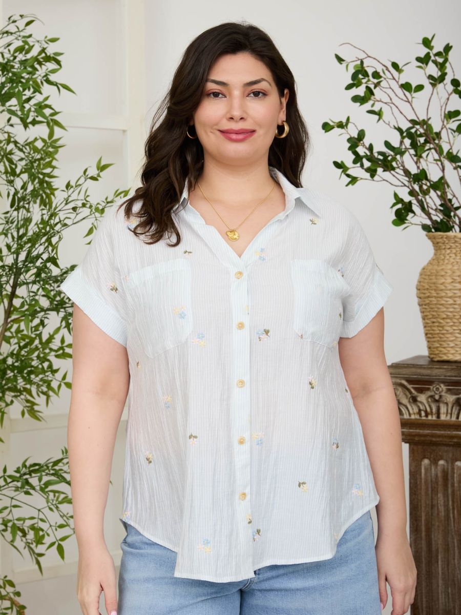 Floral Garden Short Sleeve Button-Up Shirt by Mine in light blue with subtle floral embroidery and front pockets.