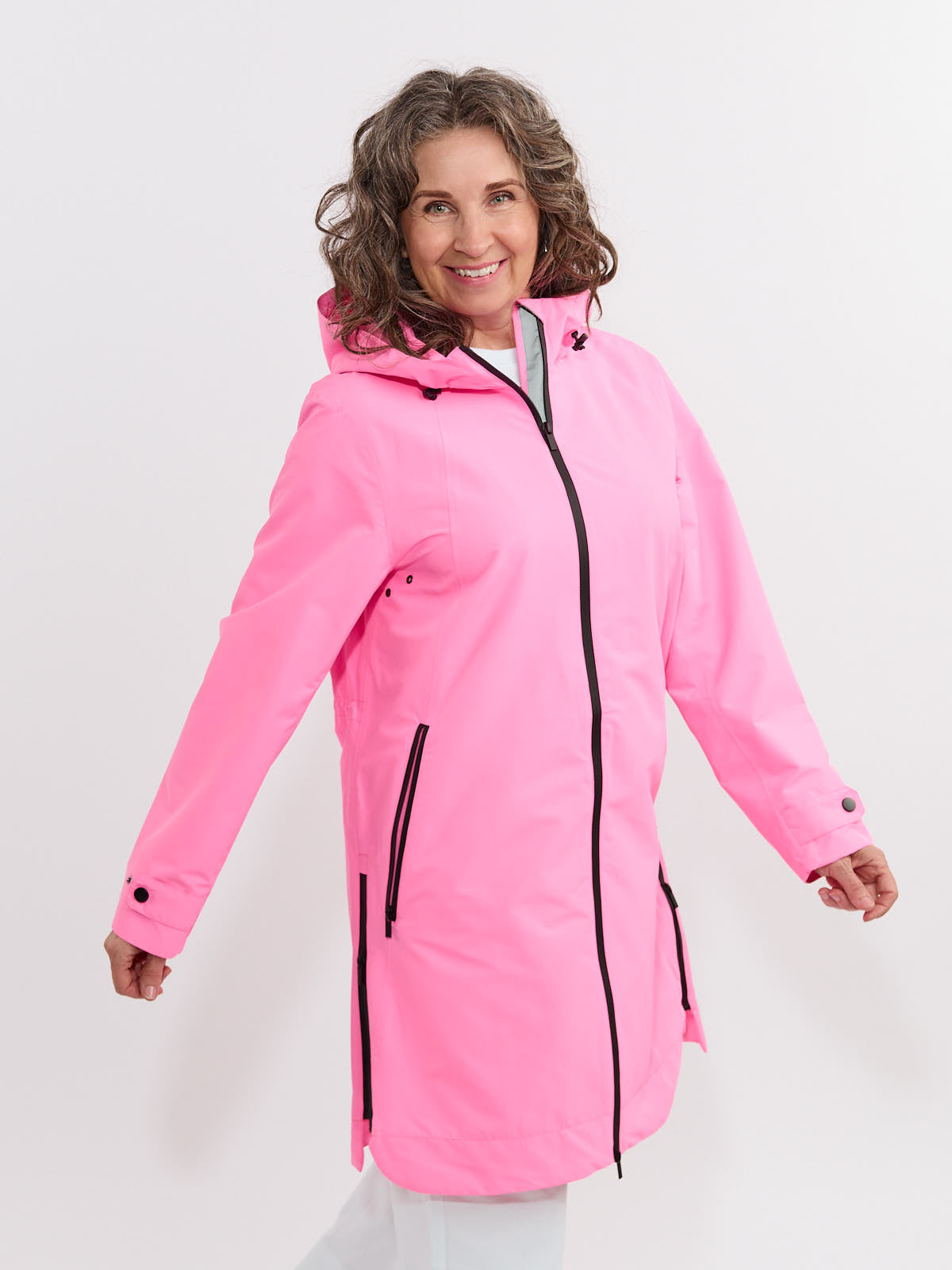 Bright pink Fashion Concepts Weather Ready 3/4 Length Waterproof Coat with black zipper on a smiling model outdoors.