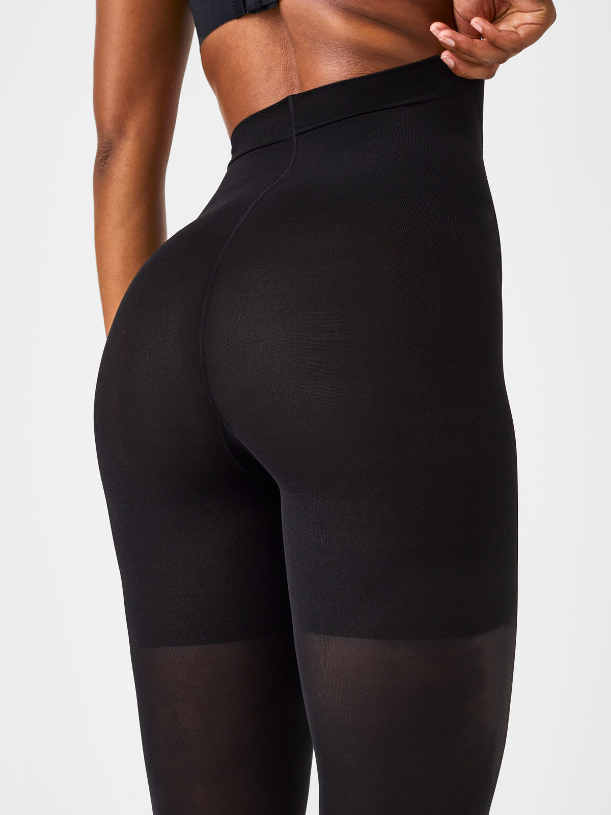 Close-up of black SPANX Luxe Leg Tight-End Control Tights by Spanx highlighting fit and smooth finish.