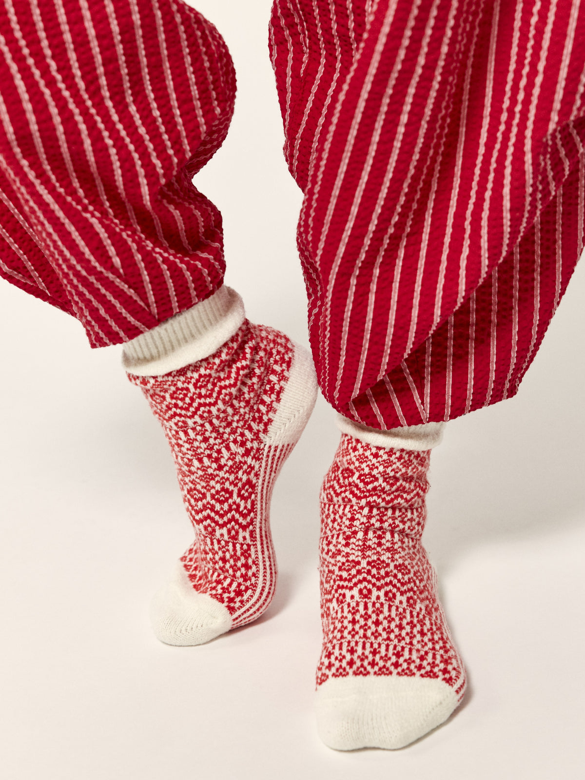 Red striped pants with patterned red and white socks”】【