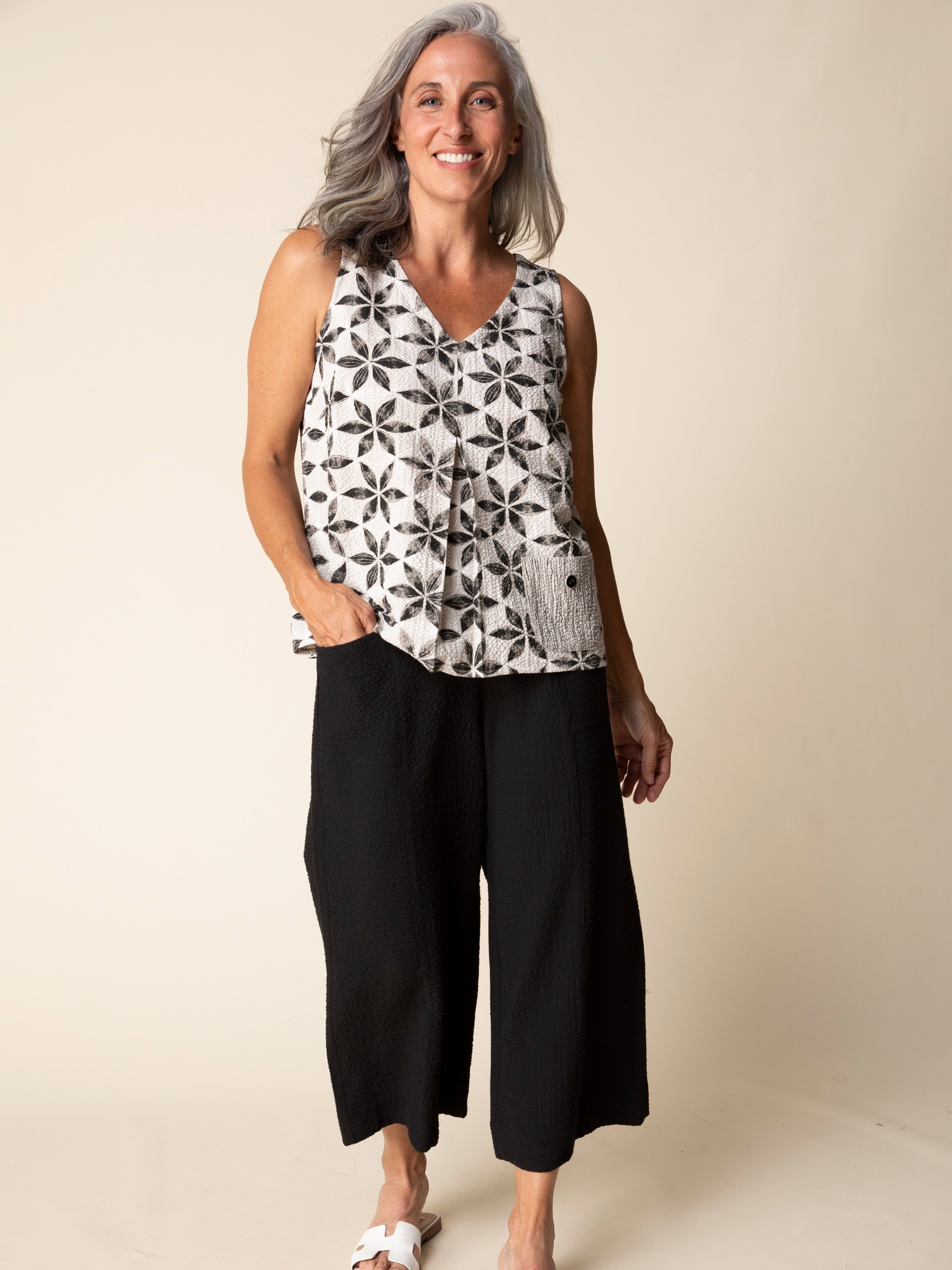 Habitat Amalfi Floral Crinkle Pocket Sleeveless Top in beige and black floral pattern with casual black pants.