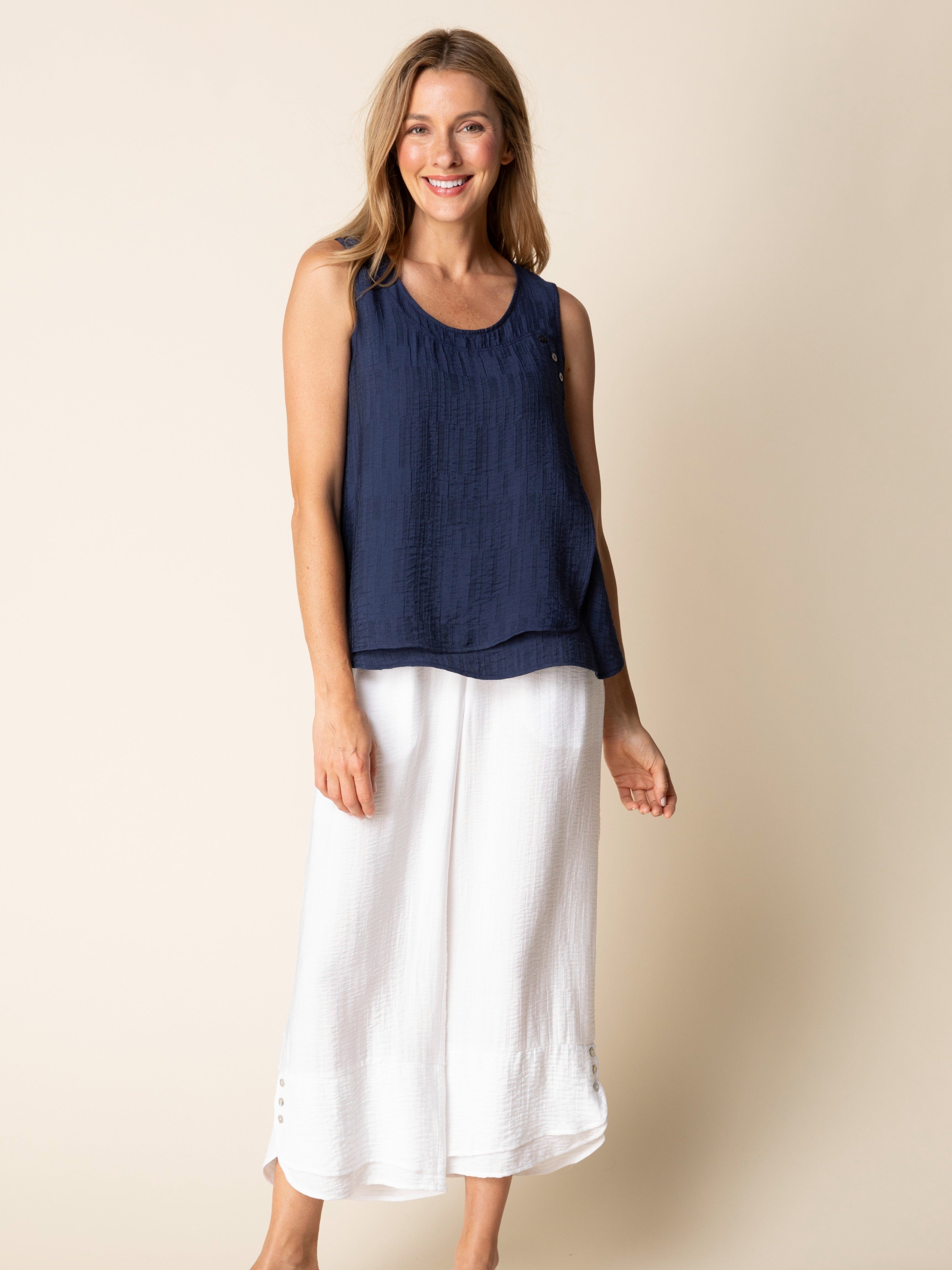 Relaxed fit Habitat Button-Layered Soft Jacquard Sleeveless Top in navy, styled with white wide-leg pants from Habitat.