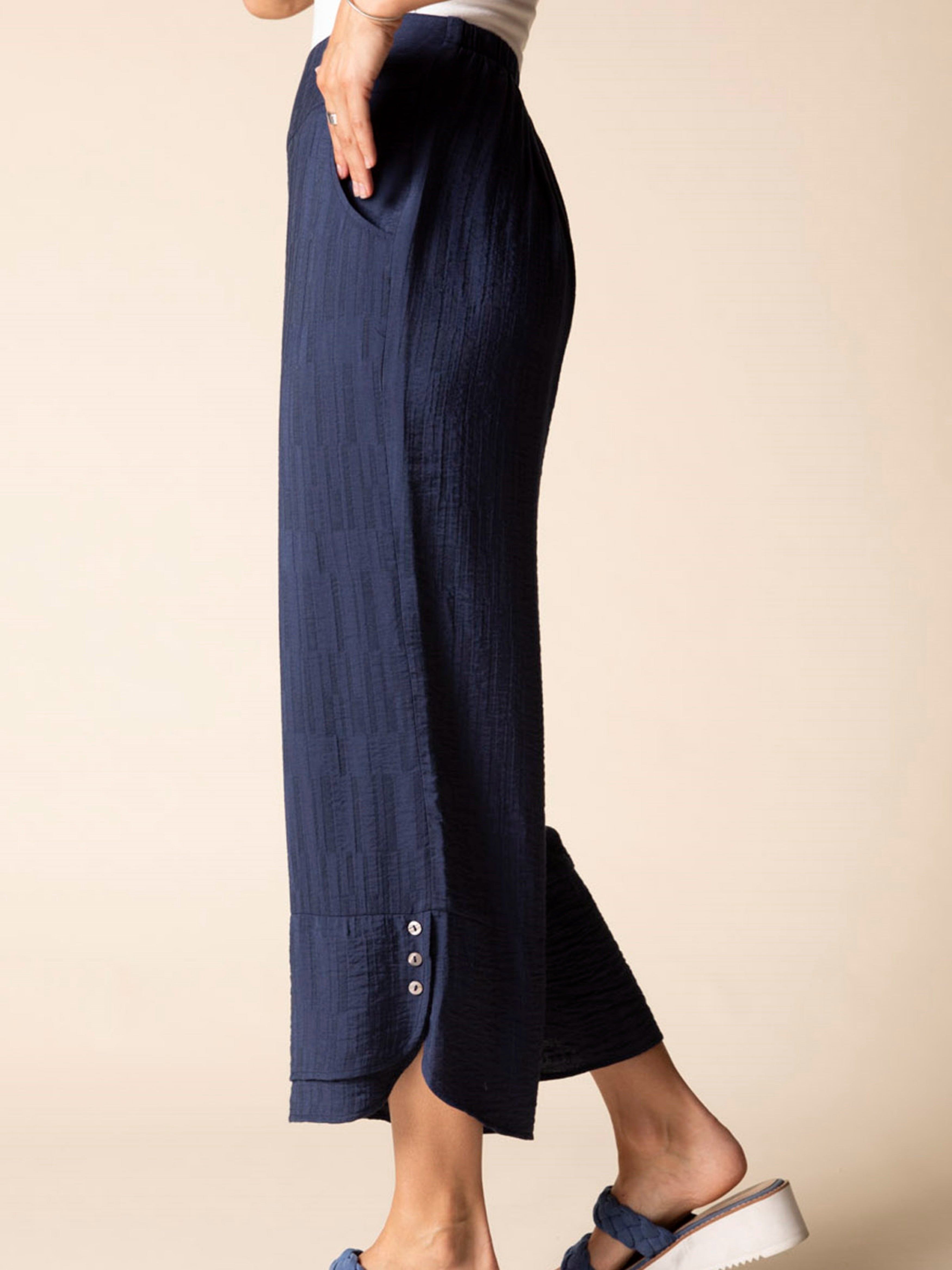 Navy textured wide-leg pants with button crop hem, styled by Habitat in soft jacquard fabric.