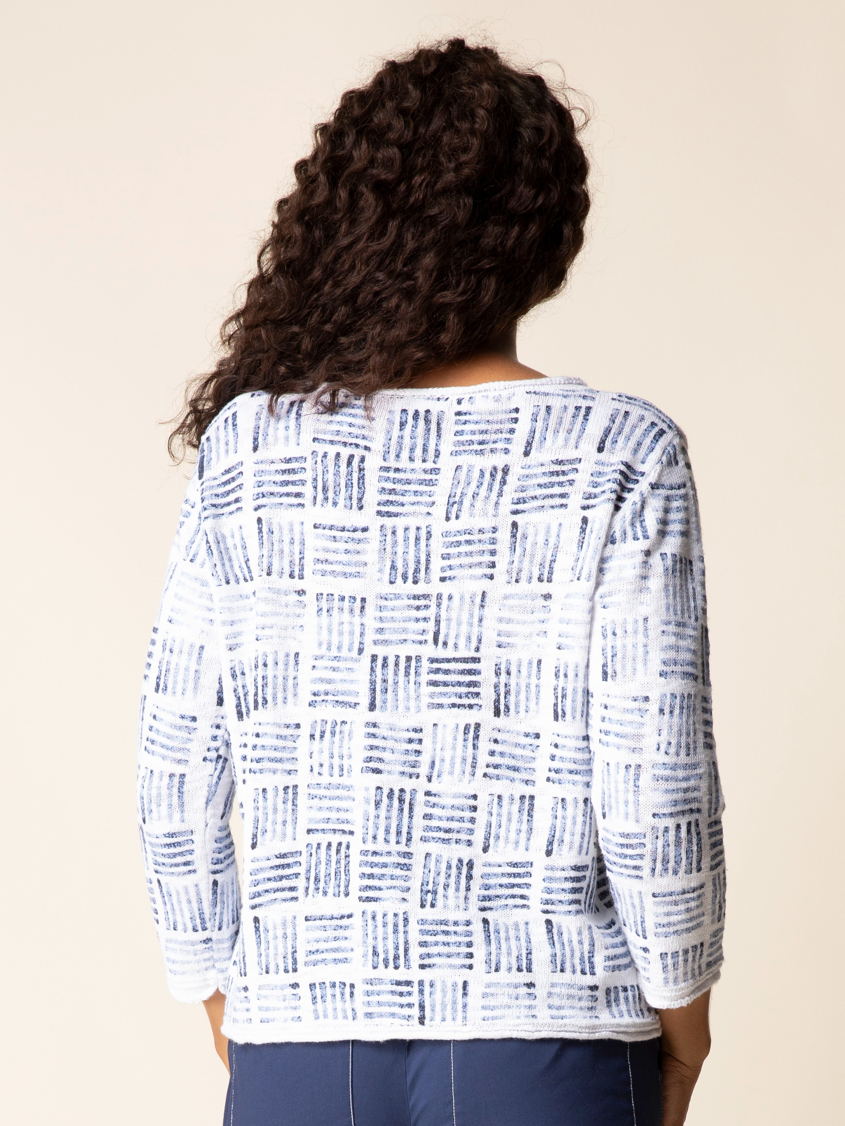 Back view of a blue and white patterned Habitat Stamped Drift Cotton Crewneck Sweater by Habitat, styled with blue pants.