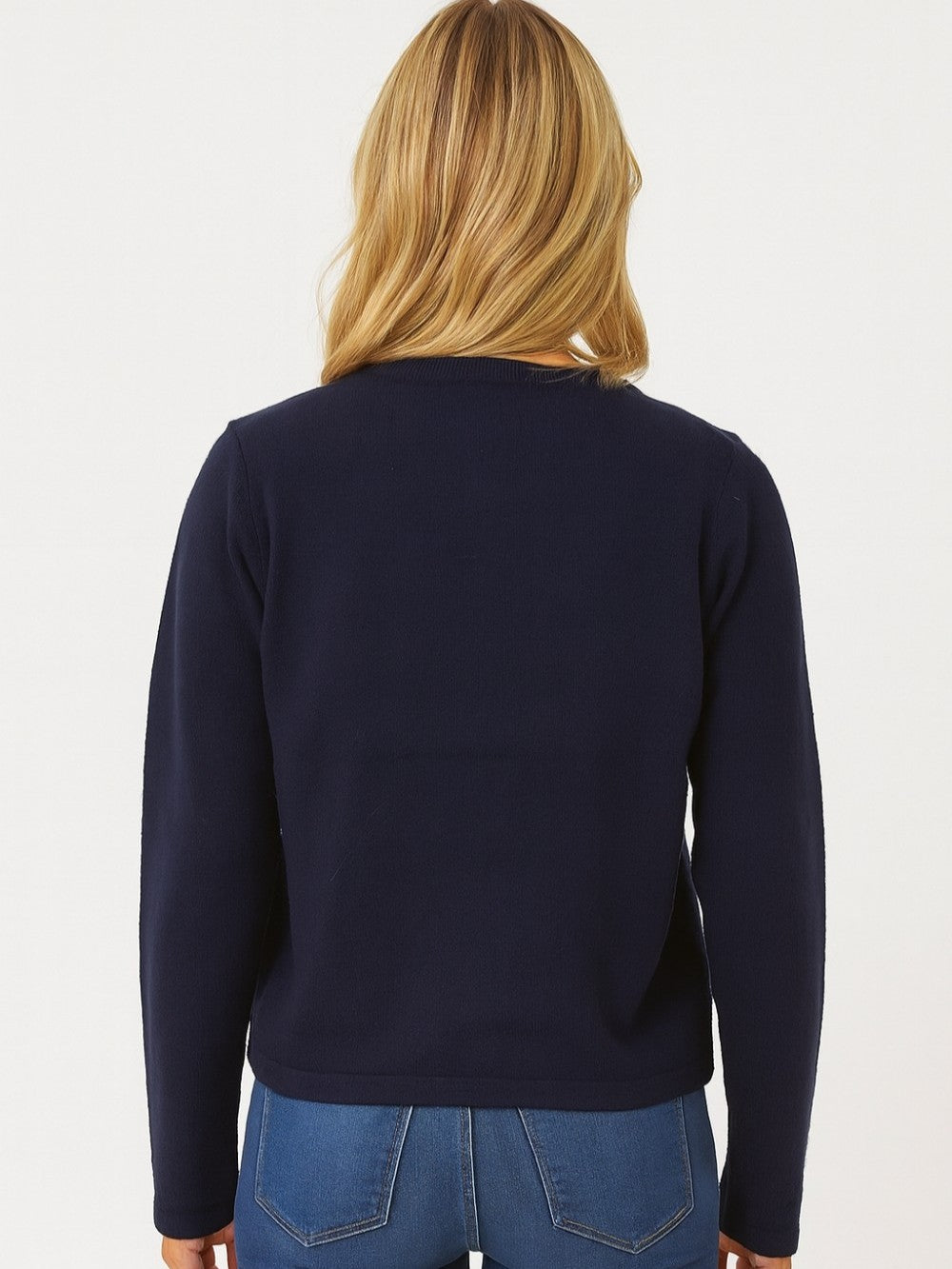 Back view of a navy jacket with long sleeves and blue jeans