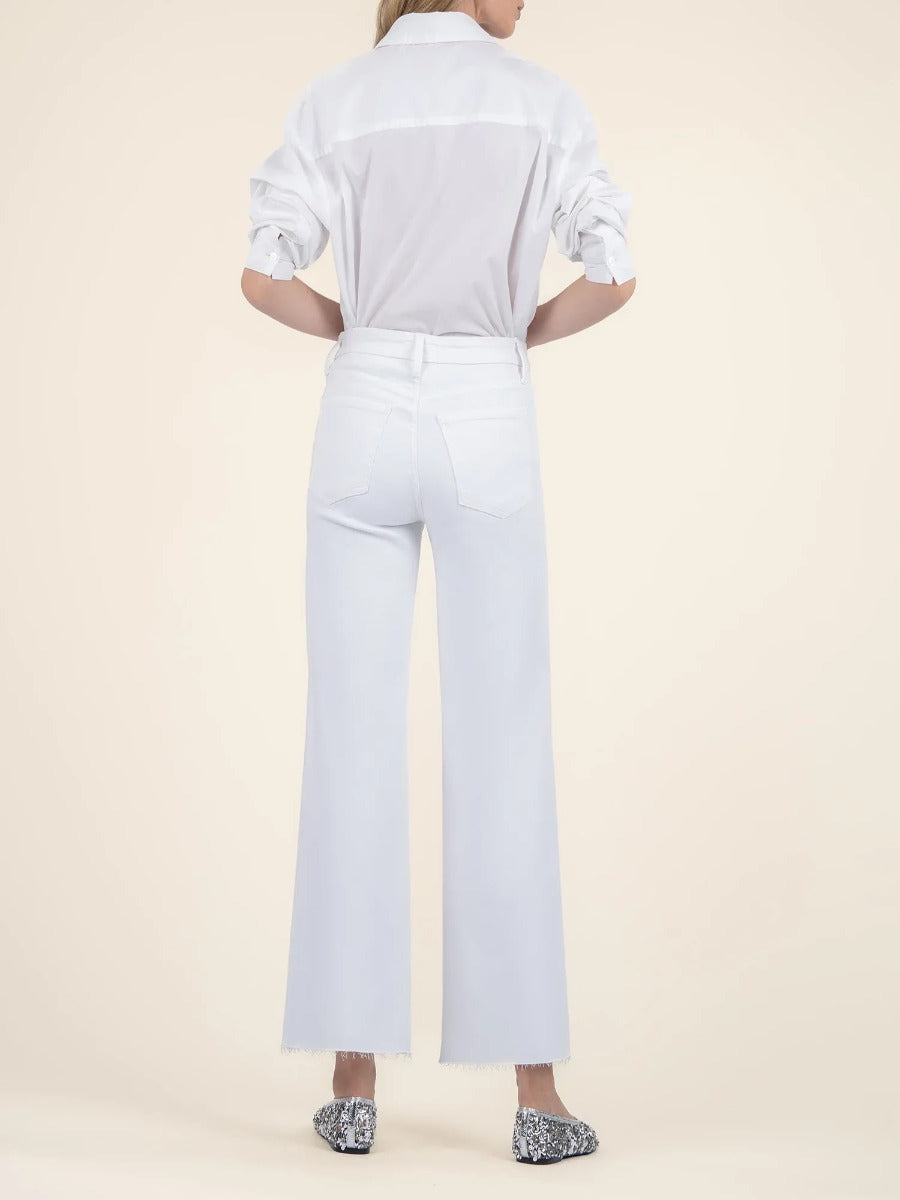 Back view of Kut from the Kloth Meg White Wide Jeans styled with a white long sleeve shirt and patterned shoes
