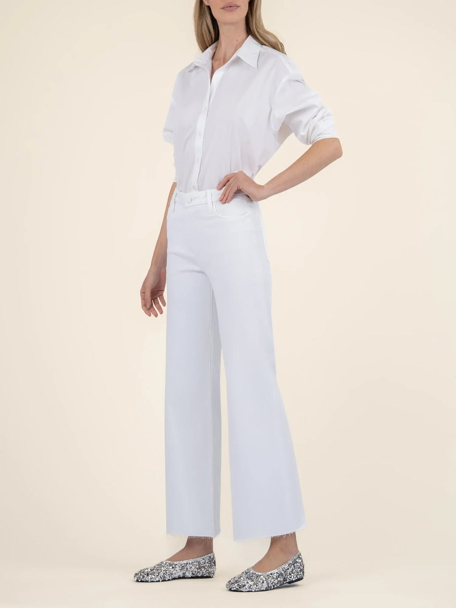 Model in white cuffed shirt paired with Kut from the Kloth Meg White Wide Jeans and patterned flats