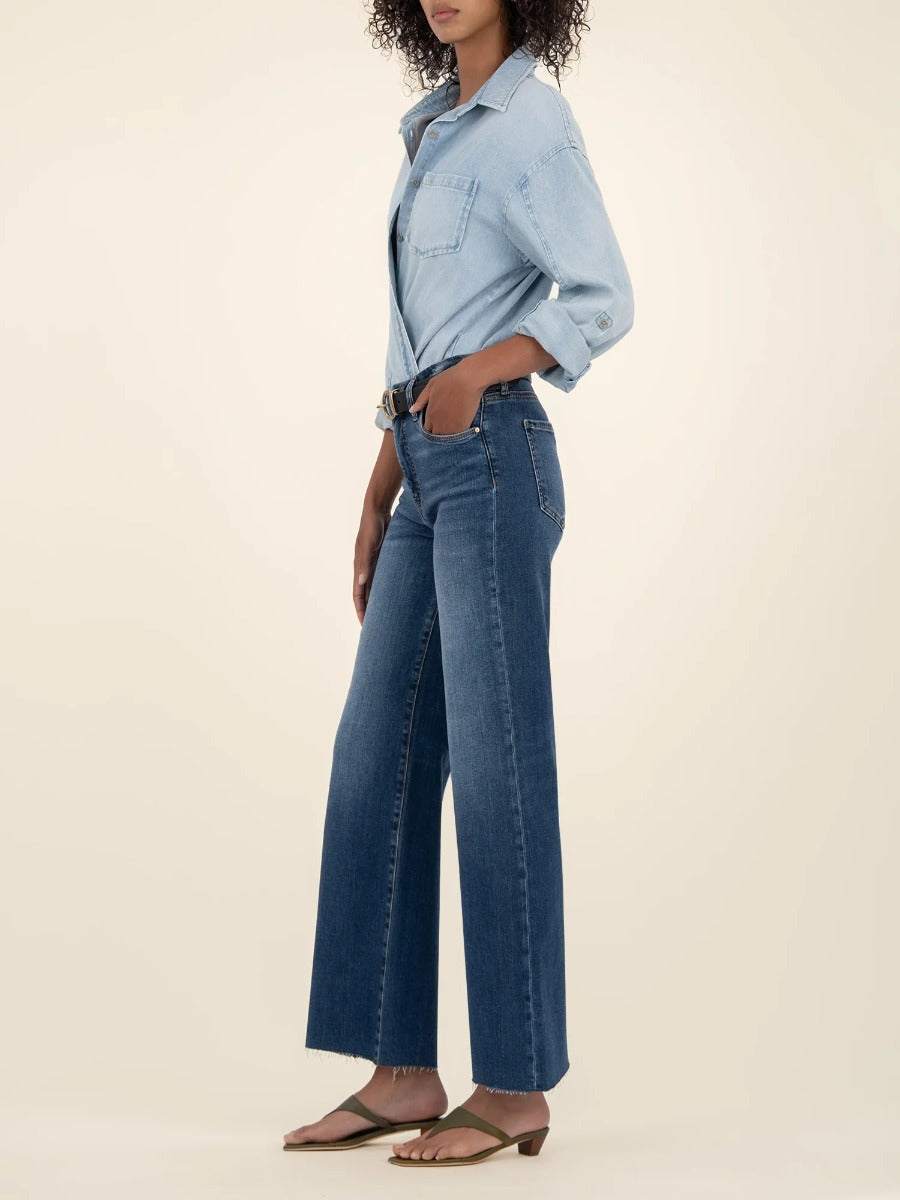 Side view of model wearing Kut from the Kloth Meg 27” High Rise Wide Jeans in dark wash denim