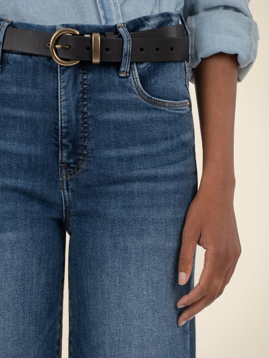 Kut from the Kloth Meg 27” High Rise Wide Jeans in dark denim with a black belt and rolled denim top sleeve