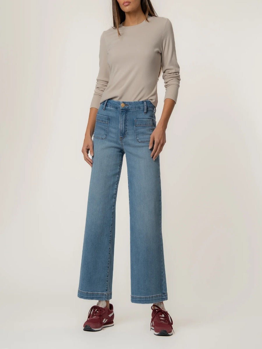 Kut from the Kloth Meg Double Trouble 27” Finish Jeans styled with a beige long-sleeve top and maroon sneakers by Kut from the Kloth