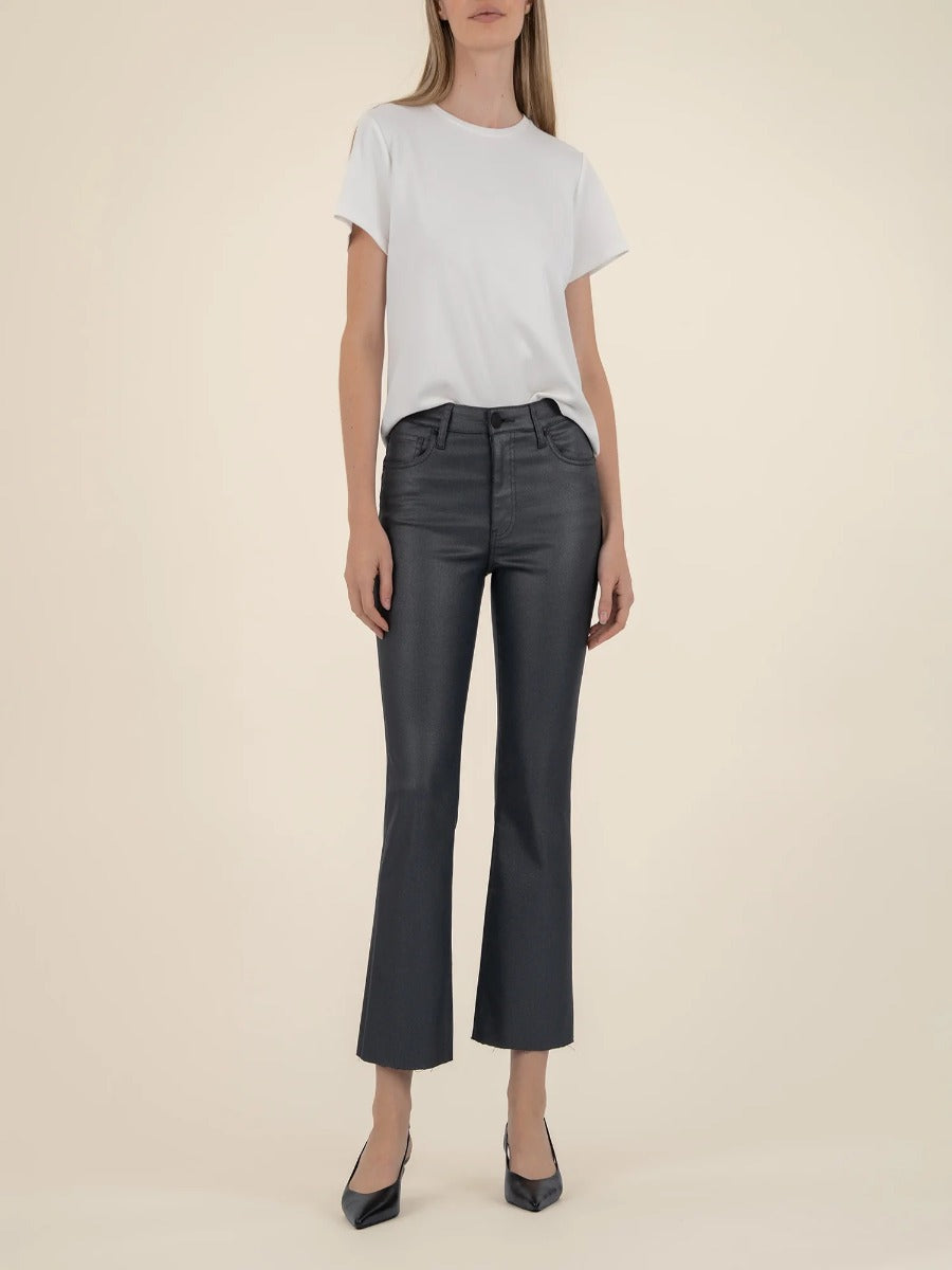 Kut from the Kloth Kelsey Shimmer Flare Jeans in black denim styled with a simple white top and black heels