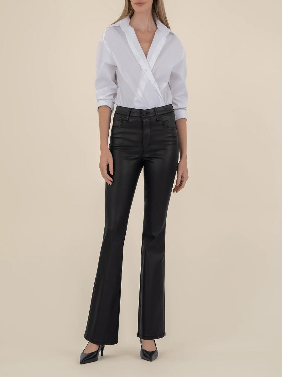 Kut from the Kloth Ana 33” Flare Jeans in black denim styled with a white blouse and black heels.