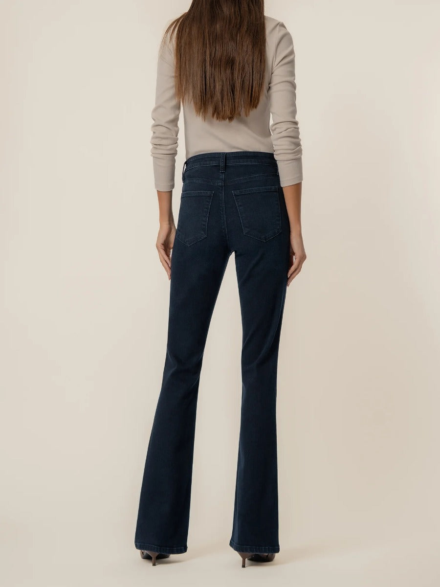 Kut from the Kloth Ana 33” Flare Denim Jeans in dark wash denim styled with a beige long sleeve top