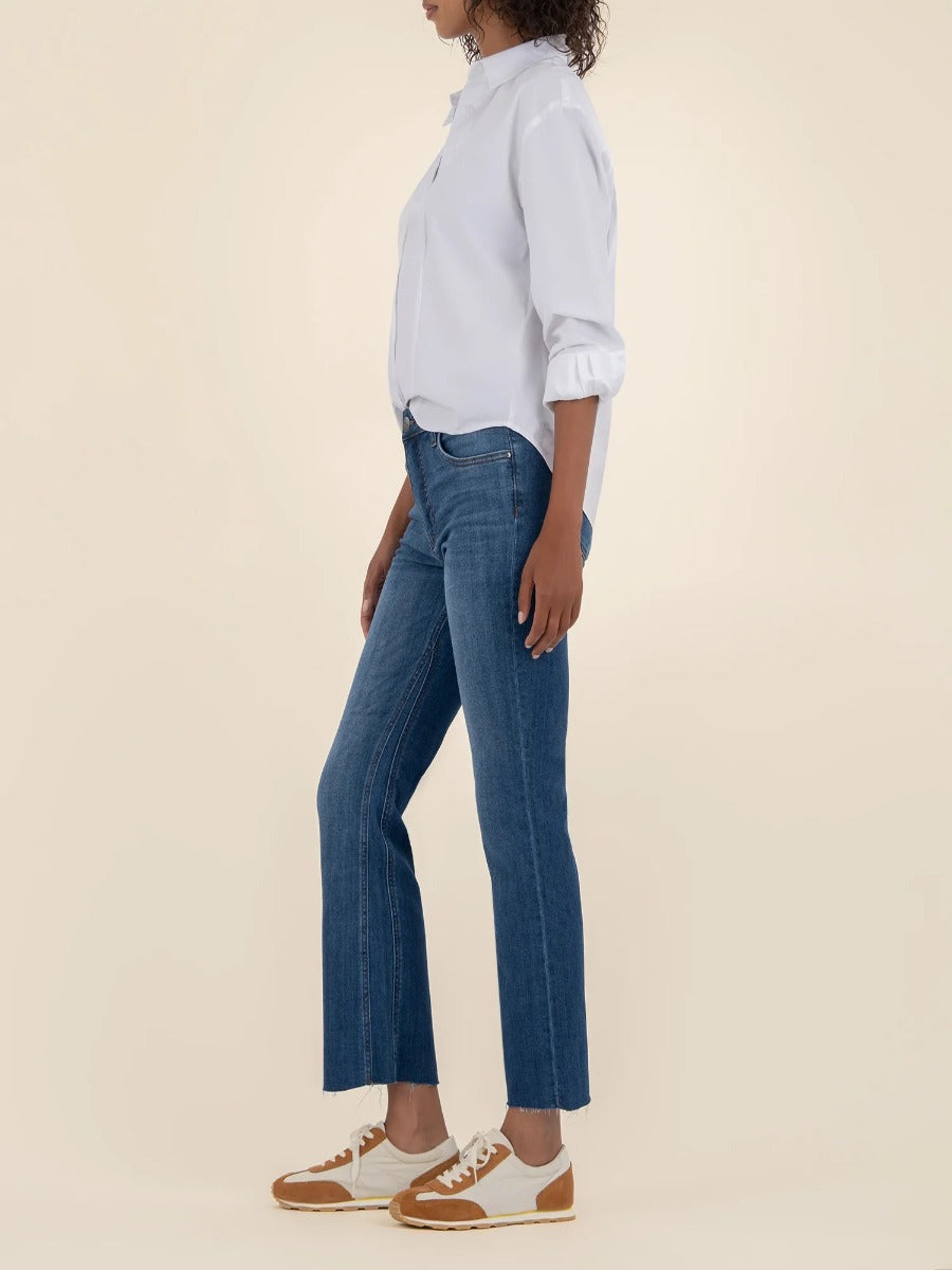 Kut from the Kloth Kelsey High Rise Flare Jeans in dark blue denim styled with casual sneakers and white shirt
