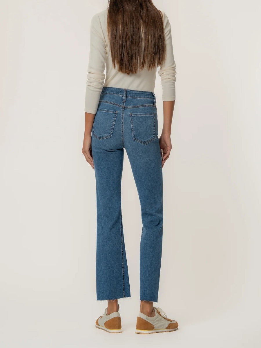 Back view of Kut from the Kloth Kelsey High Rise Ankle Flare Jeans in medium blue denim with casual sneakers.