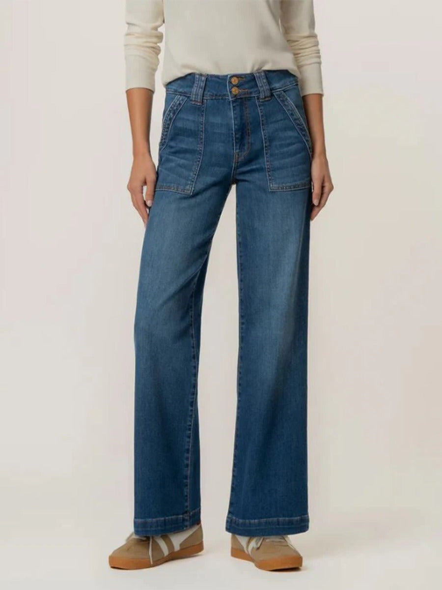Kut from the Kloth Jodi 32” Wide Jeans in blue denim styled with a cream long sleeve top and casual shoes