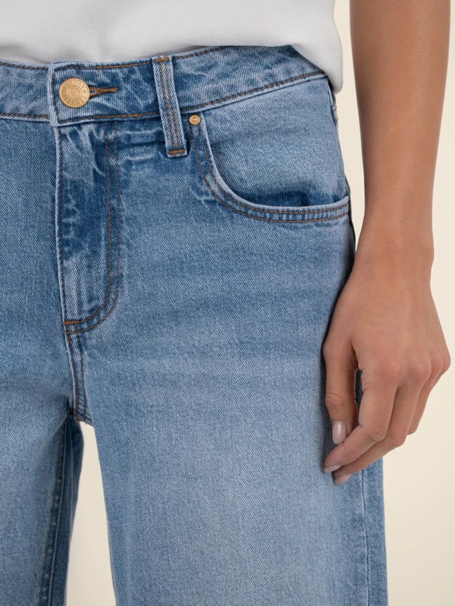 Close-up of light blue denim Kut from the Kloth Selena Baggy 31” Straight Leg Jeans with visible pocket and button detail