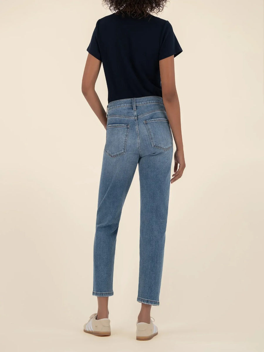Kut from the Kloth Kit High Rise Straight Leg Jeans in light denim on a figure with a black top and white sneakers