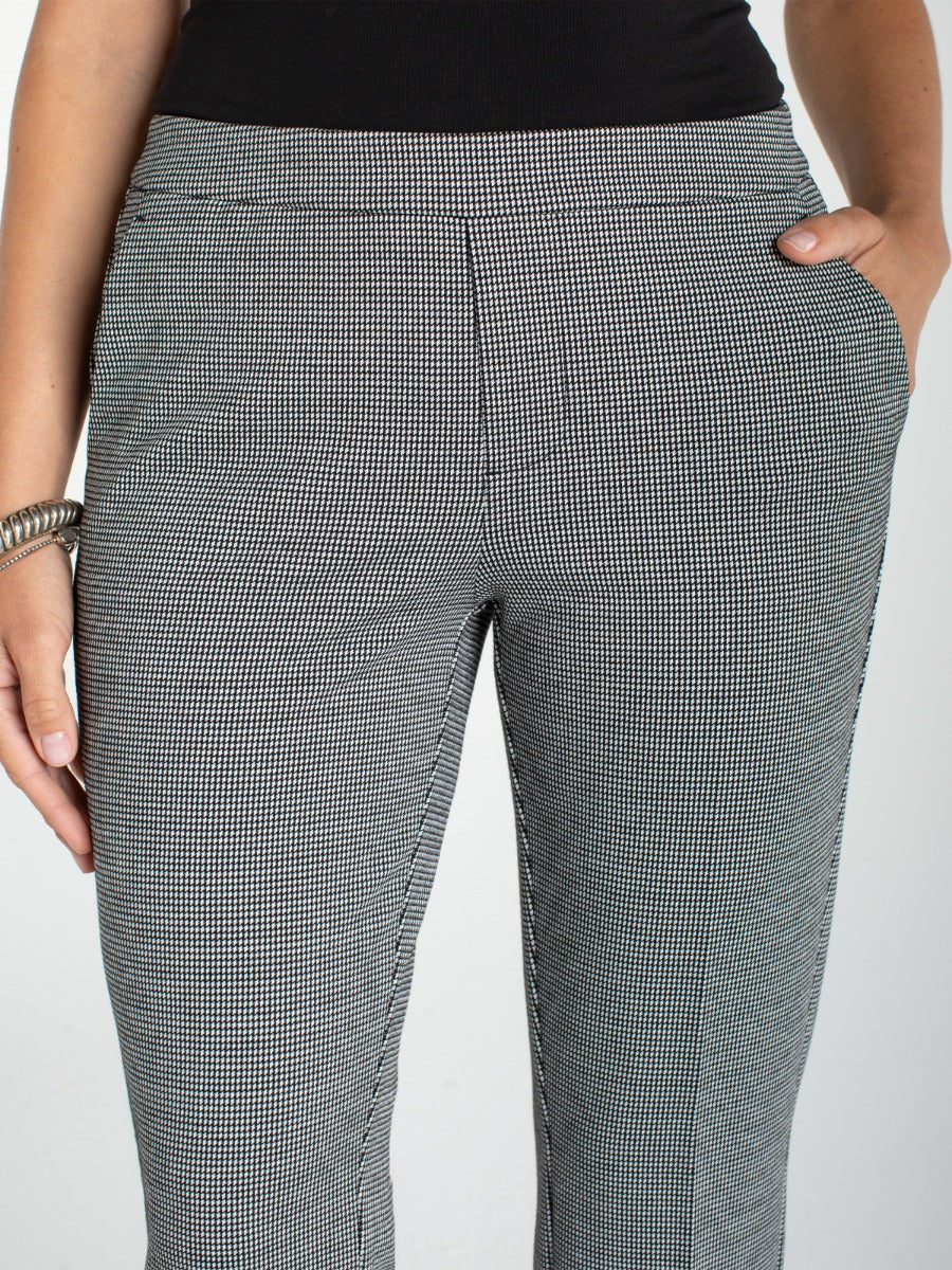 Close-up of Liverpool Kayla Pullon Trouser in black and white checkered pattern with side pockets and bracelet accessory visible.