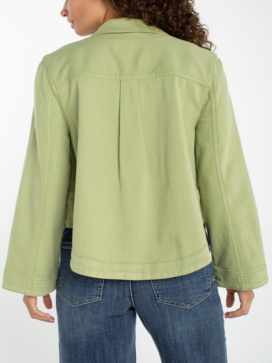 Back view of Liverpool Jana Button Front Short Blazer in light green with denim jeans, stylish outerwear by Liverpool.