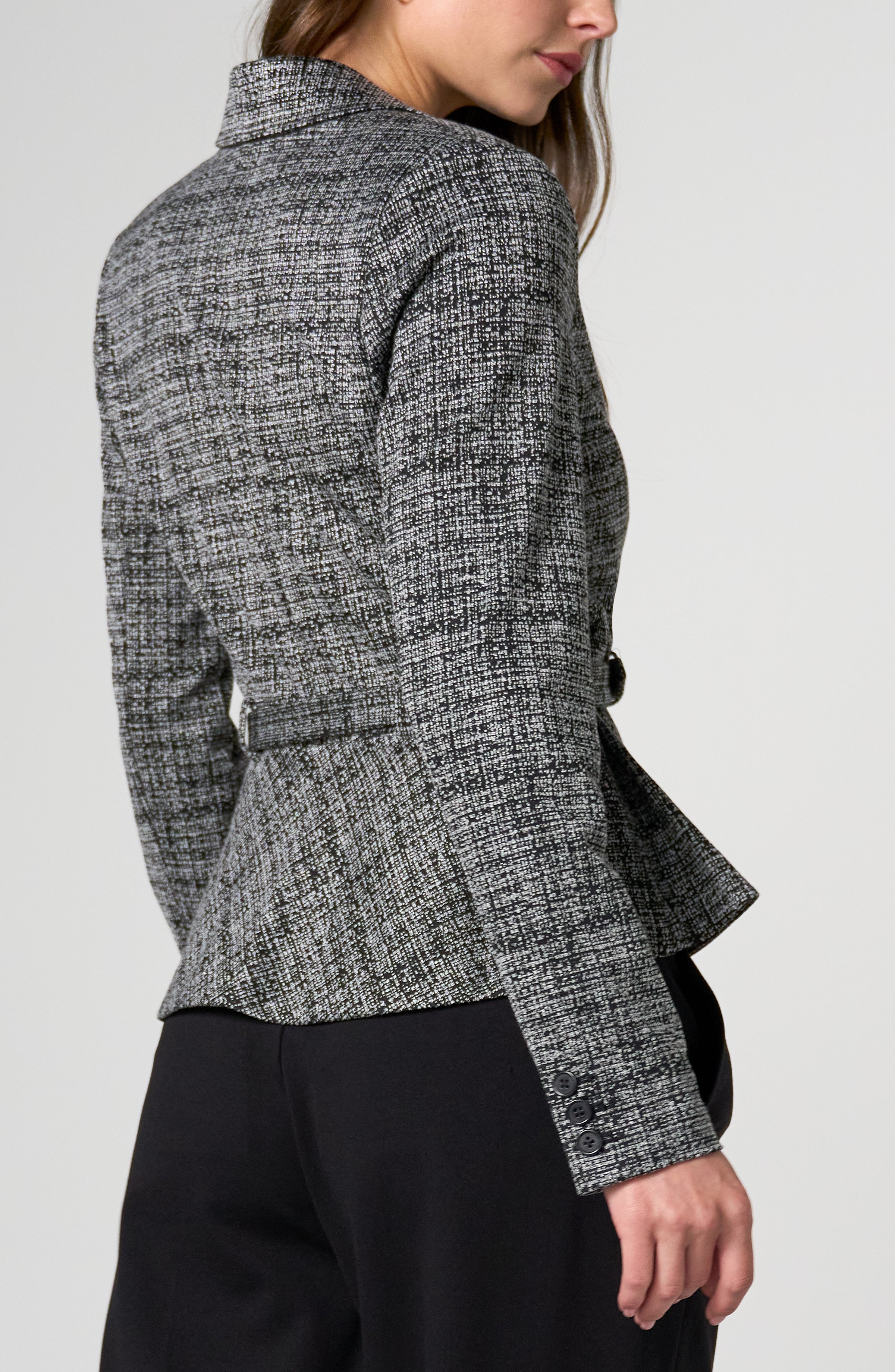 Gray and black textured tailored jacket with buttoned cuffs and a fitted waist shown from the back