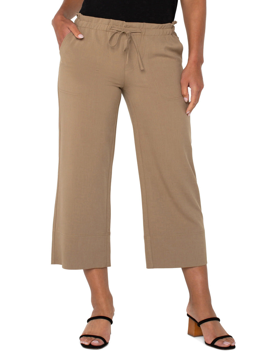 Liverpool Tie Waist Wide Leg 26” Pant in beige with drawstring waist, styled with black heeled sandals by Liverpool.
