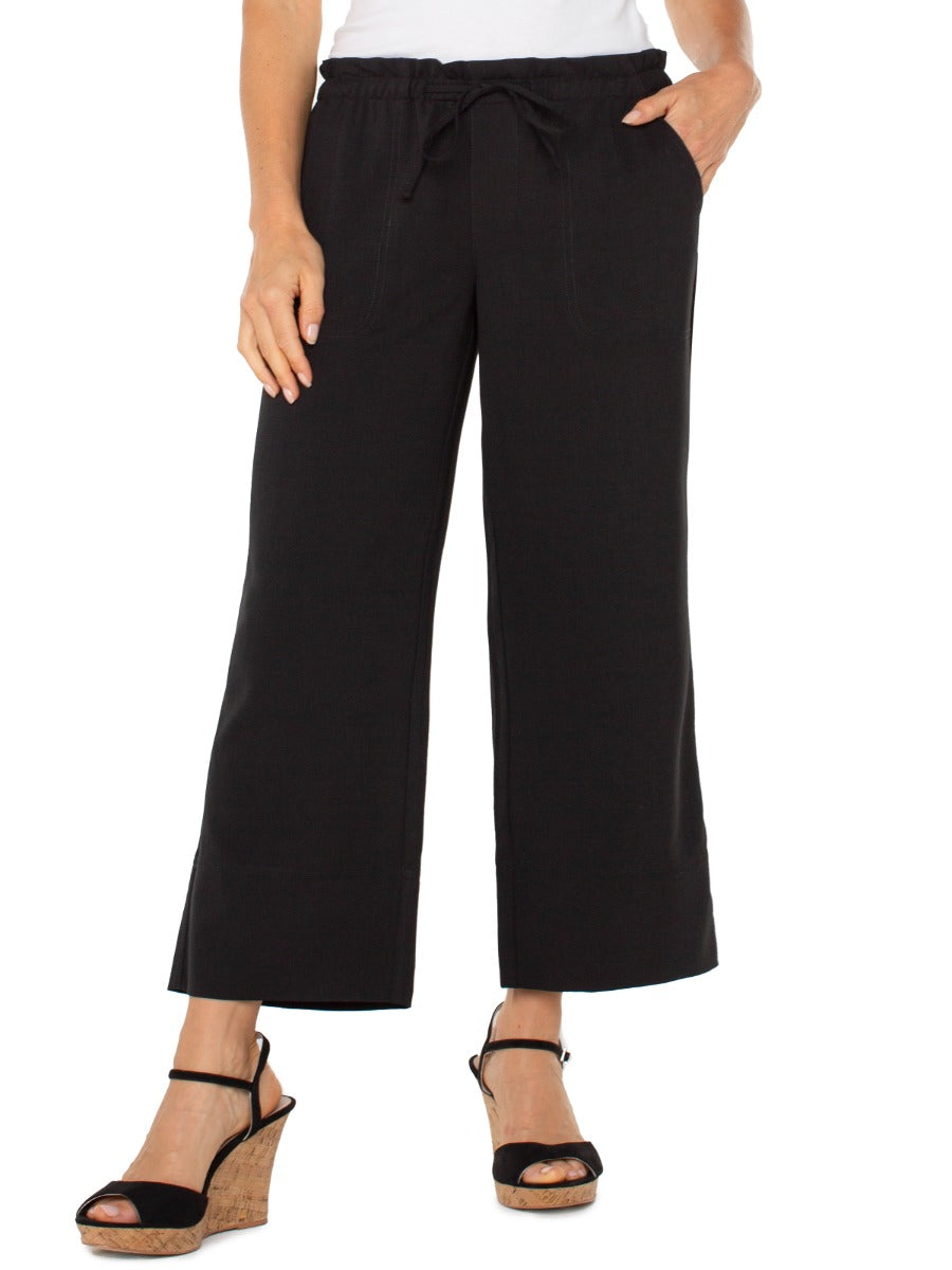 Black wide leg pants with tie waist detail paired with wedge sandals, Liverpool Tie Waist Wide Leg 26” Pant.